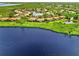 Stunning aerial view of lakeside homes with lush landscaping in a peaceful community at 4612 Club Dr # D102, Port Charlotte, FL 33953