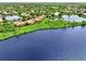 Beautiful aerial view of lakeside homes surrounded by lush greenery and serene waters at 4612 Club Dr # D102, Port Charlotte, FL 33953