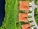 Overhead view of residential rooftops near a lake surrounded by green landscape and road at 4612 Club Dr # D102, Port Charlotte, FL 33953