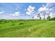 Picturesque backyard with vibrant green grass and natural vegetation leading to tranquil waterfront views at 4612 Club Dr # D102, Port Charlotte, FL 33953