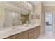 Main bathroom features double sinks, a neutral color scheme, and glass-enclosed shower at 4612 Club Dr # D102, Port Charlotte, FL 33953