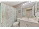 Bright bathroom features a shower with curtain, single sink vanity, and toilet at 4612 Club Dr # D102, Port Charlotte, FL 33953