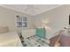 Bright bedroom features twin beds, side table, and coastal themed decor at 4612 Club Dr # D102, Port Charlotte, FL 33953