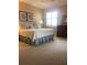 Bright bedroom boasts a king-sized bed, plantation shutters, and light neutral colors at 4612 Club Dr # D102, Port Charlotte, FL 33953