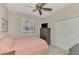 Bedroom featuring a window, fan, and closet at 4612 Club Dr # D102, Port Charlotte, FL 33953