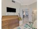Open bedroom shows dresser, guitar, and doorway to the living room at 4612 Club Dr # D102, Port Charlotte, FL 33953
