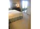 Cozy bedroom featuring a king-sized bed and sliding glass door to a private balcony at 4612 Club Dr # D102, Port Charlotte, FL 33953