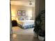 Neutral bedroom features a ceiling fan, comfortable king-sized bed, and coastal-themed artwork at 4612 Club Dr # D102, Port Charlotte, FL 33953