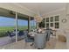 Bright dining area with modern chandelier, plantation shutters and views of the water and screened in patio at 4612 Club Dr # D102, Port Charlotte, FL 33953