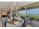 Dining table setting with seating and views through the large sliding glass doors out to the water at 4612 Club Dr # D102, Port Charlotte, FL 33953