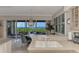 Dining area featuring a chandelier, sliding doors, plantation shutters, and lovely waterfront views at 4612 Club Dr # D102, Port Charlotte, FL 33953