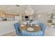 Dining area with a chandelier, table setting, and view of the kitchen and living area at 4612 Club Dr # D102, Port Charlotte, FL 33953