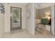 Welcoming foyer featuring tile flooring, an embellished mirror, and an open doorway to a bedroom at 4612 Club Dr # D102, Port Charlotte, FL 33953