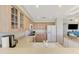 Modern kitchen with breakfast bar, white appliances, and wooden cabinetry at 4612 Club Dr # D102, Port Charlotte, FL 33953