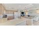 Well-lit kitchen overlooking living area, creating a seamless and inclusive space at 4612 Club Dr # D102, Port Charlotte, FL 33953
