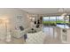 Bright living room with tile floors, a white sofa, and a view to an outdoor patio overlooking the water at 4612 Club Dr # D102, Port Charlotte, FL 33953