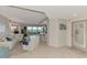 Bright and airy living room featuring a white sofa, tile floors, and panoramic water views at 4612 Club Dr # D102, Port Charlotte, FL 33953