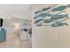 Bright and airy living room with tile flooring, coastal decor, and a partial view of a white sofa at 4612 Club Dr # D102, Port Charlotte, FL 33953