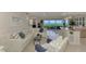 Bright living room with tile floors, a white sofa, decorative pillows, and views to the outdoor patio at 4612 Club Dr # D102, Port Charlotte, FL 33953