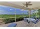 Serene screened patio with dining set overlooking lush greenery and tranquil waterfront views at 4612 Club Dr # D102, Port Charlotte, FL 33953