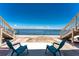 Inviting backyard with scenic water views, two staircases, and two chairs at 5041 N Beach Rd # 2A And 2B, Englewood, FL 34223
