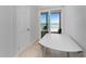 Water view from private balcony through sliding glass doors next to a white table with chairs at 5041 N Beach Rd # 2A And 2B, Englewood, FL 34223