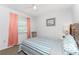 Bedroom with natural light, ceiling fan, and striped bedspread at 5041 N Beach Rd # 2A And 2B, Englewood, FL 34223