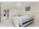 Bright bedroom features a ceiling fan, closet, neutral walls, and tiled floor at 5041 N Beach Rd # 2A And 2B, Englewood, FL 34223