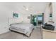 Relaxing bedroom with a ceiling fan and sliding glass door to the balcony at 5041 N Beach Rd # 2A And 2B, Englewood, FL 34223