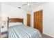 Bedroom with natural light, ceiling fan, and striped bedspread at 5041 N Beach Rd # 2A And 2B, Englewood, FL 34223