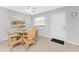 The dining area features a glass table with wicker chairs, next to a window and the entrance door at 5041 N Beach Rd # 2A And 2B, Englewood, FL 34223