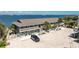 Exterior of two-story apartment building with parking and palm trees overlooking ocean at 5041 N Beach Rd # 2A And 2B, Englewood, FL 34223