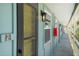 Exterior condo walkway with a door, light fixtures, and red mailboxes at 5041 N Beach Rd # 2A And 2B, Englewood, FL 34223