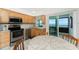 Bright kitchen includes stainless steel appliances with a dining table and access to the balcony at 5041 N Beach Rd # 2A And 2B, Englewood, FL 34223