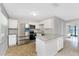 Bright kitchen featuring stainless steel appliances, granite countertops, white cabinetry, and water views at 5041 N Beach Rd # 2A And 2B, Englewood, FL 34223