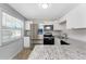 Bright kitchen with stainless steel appliances, granite countertops, tile floors, and a view out the window at 5041 N Beach Rd # 2A And 2B, Englewood, FL 34223