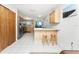 Well-equipped kitchen with stainless steel appliances and bar seating at 5041 N Beach Rd # 2A And 2B, Englewood, FL 34223