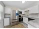 Bright kitchen featuring stainless steel appliances, granite countertops, modern white cabinets, and neutral wall colors at 5041 N Beach Rd # 2A And 2B, Englewood, FL 34223