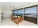 Covered lanai features expansive water views and comfortable wicker furniture at 5041 N Beach Rd # 2A And 2B, Englewood, FL 34223