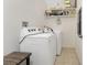 Bright laundry room with a washer and dryer and some storage shelves at 5041 N Beach Rd # 2A And 2B, Englewood, FL 34223