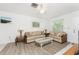 Bright living room filled with natural light, features a ceiling fan and comfortable furnishings at 5041 N Beach Rd # 2A And 2B, Englewood, FL 34223