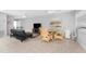 Well-lit living room featuring modern furnishing including a sofa, dining table, and TV at 5041 N Beach Rd # 2A And 2B, Englewood, FL 34223