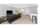 Open concept living area with tile flooring, a dining table with wicker chairs, and a comfortable couch at 5041 N Beach Rd # 2A And 2B, Englewood, FL 34223