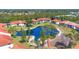 Aerial view showcasing community condos surrounding a beautiful pond and landscape at 507 Pine Hollow Cir # 507, Englewood, FL 34223