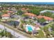 Aerial view of condos, community pool, pond, and lush neighborhood at 507 Pine Hollow Cir # 507, Englewood, FL 34223