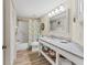 Bathroom with a tub, shower, toilet, and white vanity with granite countertop at 507 Pine Hollow Cir # 507, Englewood, FL 34223
