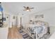 Relaxing bedroom with a ceiling fan, coastal decor, and light wooden floors at 507 Pine Hollow Cir # 507, Englewood, FL 34223