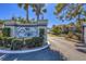 Community entrance to Pine Hollow featuring manicured landscaping and secure gate at 507 Pine Hollow Cir # 507, Englewood, FL 34223