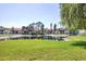 Community landscaping with a pond and exterior views of multiple units at 507 Pine Hollow Cir # 507, Englewood, FL 34223