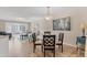 Dining room featuring light wooden floors, glass table and black chairs leading to the living room at 507 Pine Hollow Cir # 507, Englewood, FL 34223